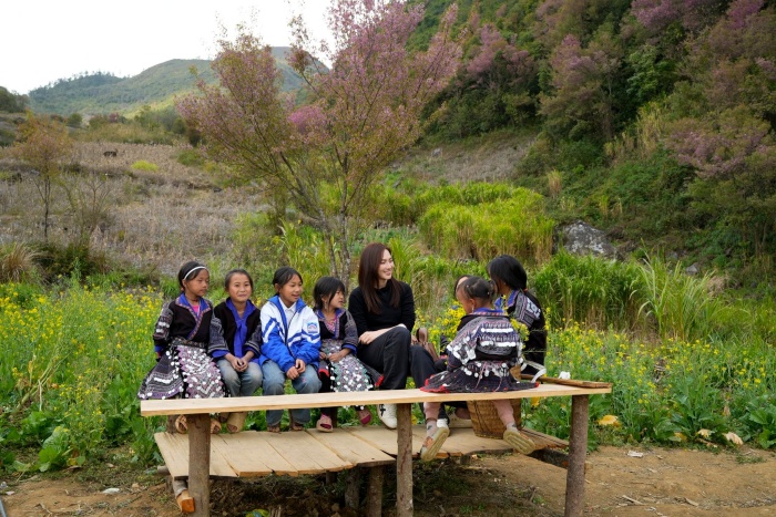 Những khung hình ghi lại cảnh cô ngồi giữa các em nhỏ trên chiếc ghế gỗ đơn sơ, trò chuyện trong không gian bản làng yên bình mang đến cảm giác rất đỗi chân thành. Không cần những cử chỉ phô trương, chính sự giản dị và chân thành trong cách cô hòa mình vào cuộc trò chuyện đã khiến khoảnh khắc ấy trở nên đặc biệt, để lại nhiều thiện cảm trong lòng người xem.